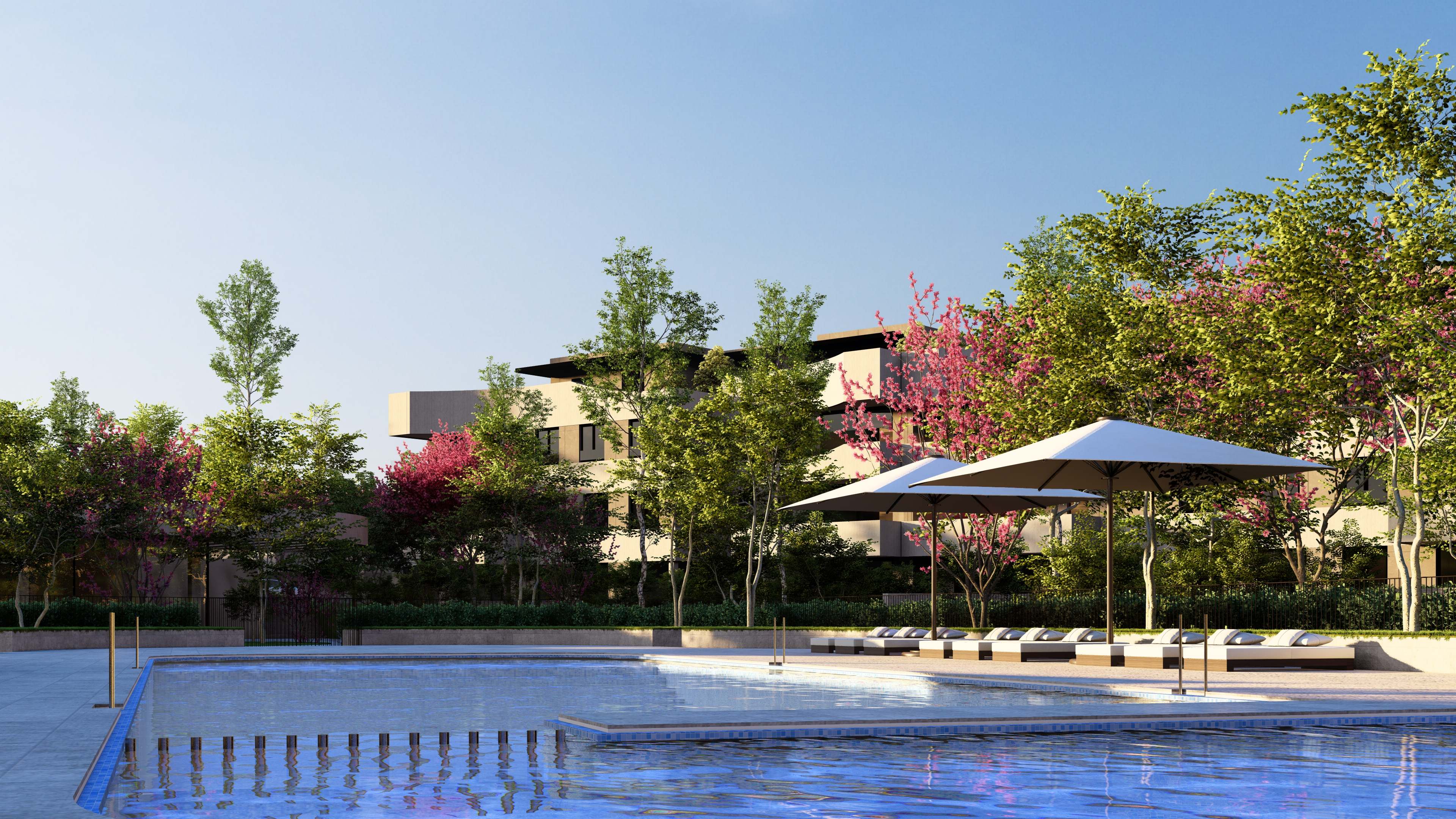 Zona de piscina comunitaria con tumbonas y jardines