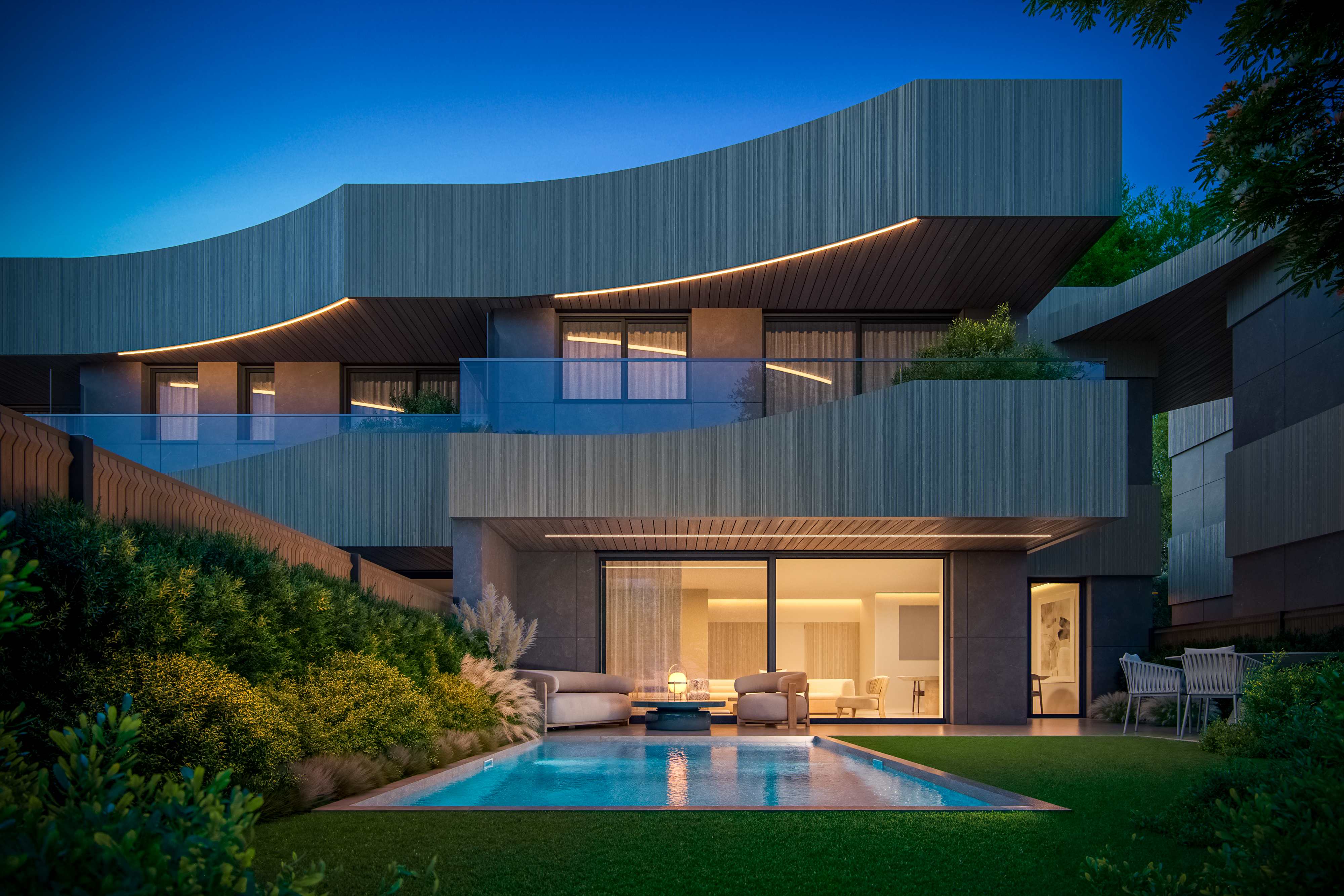 Vista nocturna de vivienda Mirage con piscina iluminada